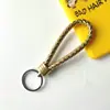 Llavero creativo de cuerda de cuero tejido a mano para pareja, llavero de coche, llavero al por mayor, colgante para bolso