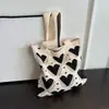 Bolso tejido nuevo para mujer, bolso de mano tejido versátil, bolso de muñeca, bolso tote, bolso tejido de poliéster, bolso grande en forma de corazón