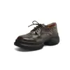 Sapatos mocassins de couro com sola de 6 cm de espessura, apresentando bico redondo, design de cadarço e um estilo retrô versátil com salto grosso.