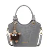 Bolso de mano tipo cubo de moda y único estilo coreano, estilo simple para el día a día, para mujer, bolso cruzado de diseño de nicho versátil casual