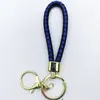 Venta al por mayor del fabricante Llavero de Cuerda de Aleación Tejida y Cuero Accesorios Colgantes Material PU Bolsas Pequeñas de Regalo Accesorios para Llaveros