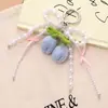 Nuevo Colgante de Teléfono Móvil Tulipán Tejido a Crochet de Lana Colgante para Bolso Serie Miu Cadena Versátil de Colgar para Teléfono Móvil con Lazo