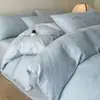 Juego de ropa de cama de lujo de satén jacquard 100% algodón de grado A de cuatro piezas, que incluye una funda nórdica y una sábana de cama 100% algodón, creando una atmósfera de dormitorio de alta gama.