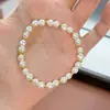 Pulsera de plata de ley S925 con perla natural de agua dulce en forma de moño y cuentas espaciadoras de plata, pulsera de cordón elástico de moda francesa de lujo ligero