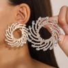 Pendientes de girasol con incrustaciones de cristal de aleación en espiral exagerada transfronteriza europea y americana, joyería femenina para la cena con temperamento al por mayor para mujer