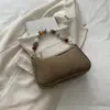 Nuevo bolso de axila con cuentas estilo chino para mujer, con textura de gamuza retro, forma de baguette, diseño único y elegante, y estilo moderno para el uso diario