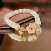 Nuevo brazalete de flor de durazno pequeño de celebridad en línea para mujer estilo antiguo ins estudiante lujo ligero diseño de nicho alto sentido regalo para amigas