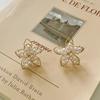 Pendientes de plata de ley 925 con forma de flor hueca de cristal y aguja de la Puerta Este de Corea del Sur, pequeños y frescos, combinables con todo.
