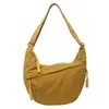 Bolso ligero de lona para mujer, nuevo diseño de nicho otoño e invierno 2026, versátil bolso casual de hombro y cruzado, bolso tipo dumpling