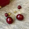 Pendientes de bola redonda roja Ankora, Lujo ligero, Pendientes exquisitos y de alta gama, Pendientes de nicho modernos y elegantes para mujer