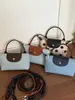 Bolso Cubo de Diseño Nicho Coreano con Parches de Lunares para Mujer 2026 Modelo Nuevo Exquisito Bolso de Hombro Cruzado para el Viaje Diario