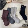 Calcetines de cachemira gruesos y cálidos con diseño simple de invierno, calcetines de tubo retro japoneses Joker con letra X pequeña para mujer, venta al por mayor