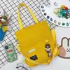 2025 Nuevo Estilo Coreano Bolso de Lona de Color Puro Simple Mochila Ligera Moda para Estudiante de Primaria Bolso Tote Escolar de Moda