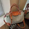 Bolso de mano de paja versátil de moda transfronterizo para mujer, nuevo bolso de hombro cruzado de gran capacidad informal para el verano de 2026
