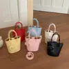 Bolso para teléfono móvil de mujer estilo extranjero, nuevo y popular 2026, bolso de mano pequeño súper moderno para el trabajo, bolso tipo cubo para el hombro y cruzado