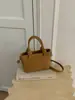 Bolso tote pequeño surtido super caliente transfronterizo para mujer 2026 nuevo nicho sentido de alta gama para ir al trabajo bolso cruzado tipo cubo