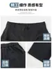 Calça de terno cinza escuro com caimento sofisticado, nova coleção outono 2026 feminina, cintura alta, solta, casual, plissada, perna larga