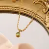 Collar vintage de moda con diseño de arroz dorado pequeño para mujer, de oro K, ligero, de lujo, de alta gama, con colgante de jade verde Dongling, cadena de clavícula.