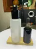 Tapa blanco y negro translúcido esmerilado 50ml botella sub-botella de loción de presión vidrio 100ml botella rociadora cosmética venta al por mayor