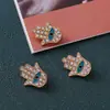 Personalidad europea y americana ojo de diablo palma pequeña aleación gota de aceite taladro accesorios de joyería colgante simple accesorios venta al por mayor