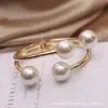 Fuente de joyería transfronteriza en stock pulsera de perlas apertura elástica metálica joyería al por mayor fábrica de joyería de comercio exterior yiwu