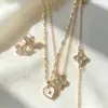 Novo conjunto de joias versátil com pingente de trevo e coração para mulheres, incluindo corrente para clavícula, brincos e acessórios de pulseira