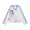 Camiseta de manga larga con cuello en V y estampado de dibujos animados estilo americano para mujer, otoño 2026, top versátil casual holgado con bloques de color y manga raglán