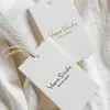 Nueva etiqueta de ropa logo cordón etiqueta Etiqueta para mujer precio personalizado tarjeta colgante etiqueta estilo natural artístico