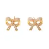 Aretes Metálicos de Moño para Mujer, Incrustados con Diamantes, Pendientes Elegantes con un Toque de Lujo, Delicados y Compactos, Estilo Lujo Ligero, Modernos para el Trayecto
