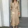 2026 Roupas Femininas Transfronteiriças Europeias e Americanas Simples Casuais Casaco Trench Coat Longo com Lapela Manga Longa Bolsos Cinto Vestido
