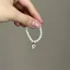 Mini Labubu Cuarta Generación Caja Sorpresa Ropa de Muñeca Collar Colgante Labubu 26 Letras Collar de Perlas Accesorios de Joyería