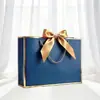 Empaque Lazo de Regalo Personalizado Bolsa de Papel de Mano Bolsa de Compras Lista para Usar Exportación Transfronteriza Impresión de Logotipo Fabricante Envío Gratis