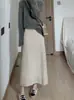 Saia de malha de lã de comprimento médio para mulheres, novo estilo coreano outono/inverno 2026, modeladora, versátil, corte reto, que valoriza o quadril, moderna
