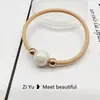 Nueva cuerda para el pelo simple de perlas, diadema, banda elástica, cuerda para la cabeza con cubierta de cuero para mujer, versión coreana de Banda Elástica al por mayor, anillo para el pelo de alta elasticidad