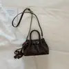 Bolso de mano tejido de estilo coreano de alta moda para mujer, otoño temprano 2026, bolso tote pequeño, bolso de hombro tipo cubo elegante y simple
