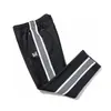 Pantalones bordados de mariposa transfronterizos con franjas laterales en blanco y negro, pantalones deportivos casuales unisex, estilo pareja universitaria al por mayor