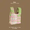 Bolsa de mão de tricô de alta qualidade com retenção automática, blocos de cores retrô, alça de pulso, versão coreana, bolsa de gato, bolsa versátil para mulheres