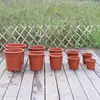 Fabricantes directos suministran macetas rojas de esquina tipo E con base de patas en ángulo alto maceta de plástico macetas de doce esquinas base macetas para semilleros