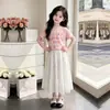Moda de Verano Casual con Estampado de Flores Top de Manga Corta para Niños Mayores 2026 Nuevo Dulce y Lindo Conjunto de Dos Piezas con Falda Larga