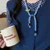 Colar de Lã Tricotado com Contraste de Cores e Contas Feminino 2025 Novo Luxo Acessível Design de Nicho Acessórios de Corrente para Suéter
