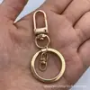 Juego de Tres Piezas de Hebilla de Puerta Negra Mate, Hebilla de Puerta Dorada Más Gancho Giratorio Dorado Claro en Forma de Ocho con Anillo Plano Accesorios de Llave Transfronterizos