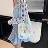 Bolsa de punto calada de nuevo estilo para el verano 2025, bolsa tejida de un solo hombro, gran capacidad, para el trabajo, bolsa tote floral de alta gama para mujer
