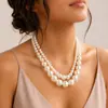 Collar de perlas sintéticas de doble capa para mujer, cadena de clavícula de lujo de alta gama, accesorio versátil y elegante para vestidos de noche