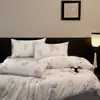 Juego de ropa de cama de cuatro piezas de lujo ligero de alta gama Lyocell Tencel para verano, funda de edredón de seda helada, sábana, sábana bajera, productos de ropa de cama