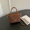 Bolso de mano de leopardo de corte relajado, bolso tipo cubo nuevo para mujer 2026, moda coreana moderna, bolso de hombro y bolso cruzado únicos