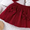 Conjunto de Roupa Infantil Novo Mais Vendido na Fronteira, Estilo Europeu e Americano, Conjunto de Duas Peças com Top de Manga Bufante em Forma de Coração com Laço e Saia Curta para Meninas