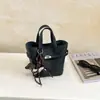 Comercio exterior bolsa de mano de lujo ligero con tacto de alta gama, bolsa tipo cubo para mujer, nuevo otoño, retro, versátil, patrón de lichi, bandolera única