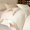 Estilo de lujo ligero juego de cuatro piezas de algodón lavado algodón four-piece simple jacquard en relieve funda de edredón sábana para cama estudiante juego de tres piezas