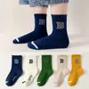 Calcetines para niños primavera otoño e invierno calcetines para mujer niños y niñas calcetines de tubo medio calcetines de algodón peinado sin costuras lindo niñas dibujos animados morado