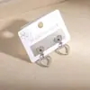 Novos Brincos Exquisitos em Aço Inoxidável em Formato de Coração Transfronteiriços, Moda Europeia e Americana Versátil Design Criativo Brincos de Coração Vazado